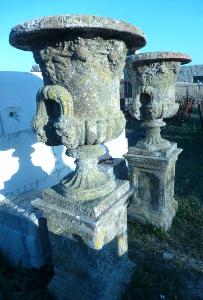 PAIR OF REONSTITUED STONE MEDICIS STYLE URNS.