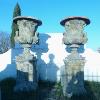 PAIR OF REONSTITUED STONE MEDICIS STYLE URNS.