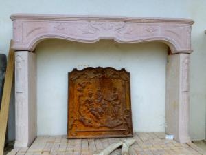  CARVED STONE FIREPLACE.